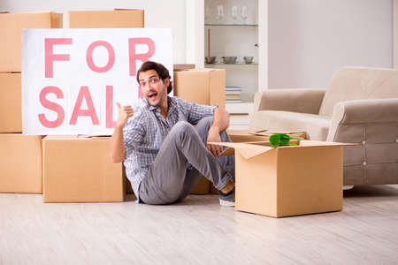 Young man offering home for sale and moving out
