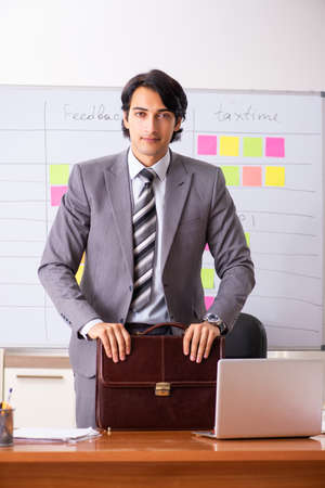 Young handsome employee working in the officeの写真素材