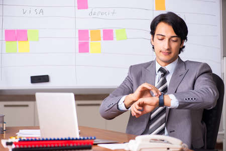 Young handsome employee working in the officeの写真素材
