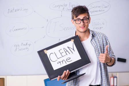 Young it specialist in front of the whiteboardの写真素材