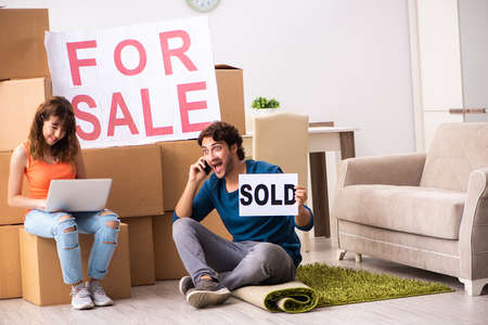 Young family offering house for sale and moving outの写真素材