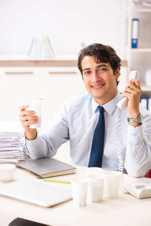 Young employee addicted to coffeeの写真素材