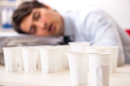 Young employee addicted to coffeeの写真素材