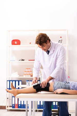 Young female patient visiting male doctor traumatologistの写真素材