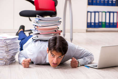 Extremely busy employee working in the officeの写真素材