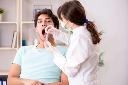 Doctor getting saliva test sample in clinic hospital