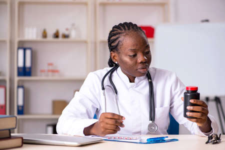 Black female doctor working at clinic