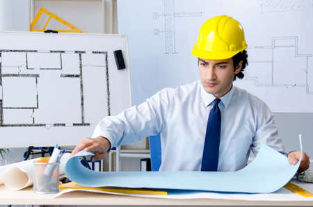 Young handsome architect working on the project