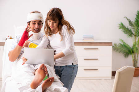 Loving wife looking after injured husbandの写真素材