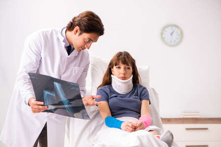 Young doctor examining injured patient