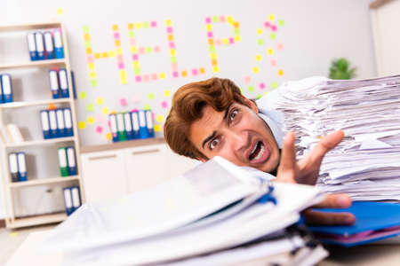 Young employee suffering from excessive workの写真素材