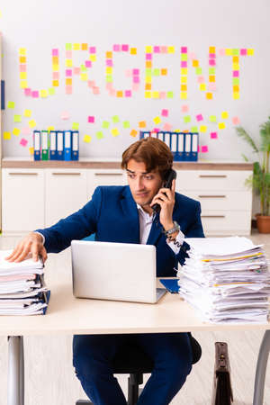 Young employee suffering from excessive workの写真素材