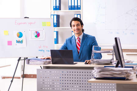 Male sales analyst in front of the whiteboardの写真素材