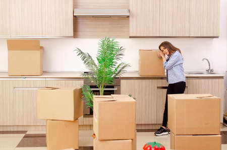 Young beautiful woman moving to new flat
