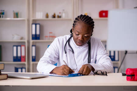 Black female doctor working at clinicの写真素材