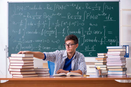 Young male student studying math at schoolの写真素材