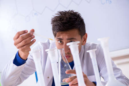 Young chemist sitting in the lab
