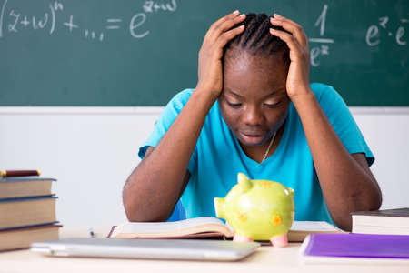 Black female student in front of chalkboardの写真素材