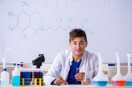Young chemist sitting in the lab