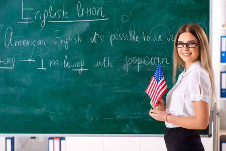 Young female english language teacher standing in front of the bの写真素材