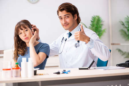 Patient with hearing problem visiting doctor otorhinolaryngologiの写真素材
