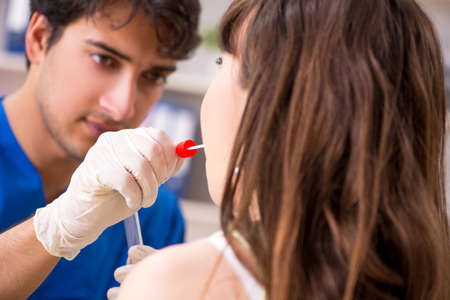 Doctor getting saliva test sample in clinic hospital