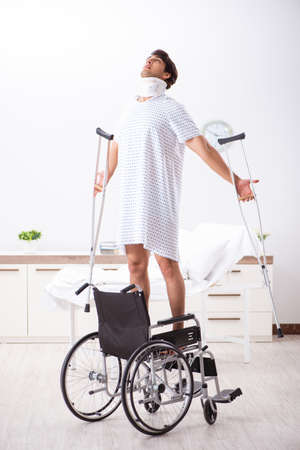 Young handsome man in wheelchair at the hospitalの写真素材