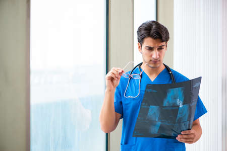 Young handsome doctor working in the hospital