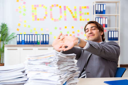 Young handsome employee sitting at the officeの写真素材