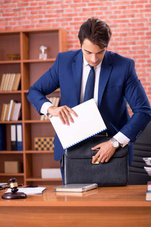 Young handsome lawyer working in his officeの写真素材