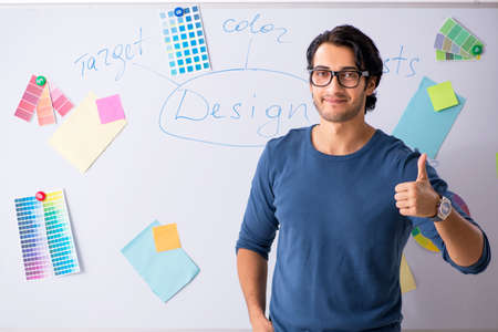Young handsome designer working at the project