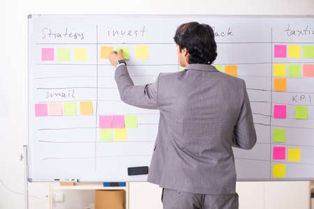 Young handsome employee working in the officeの写真素材