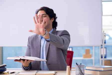 Young handsome teacher in front of whiteboardの写真素材