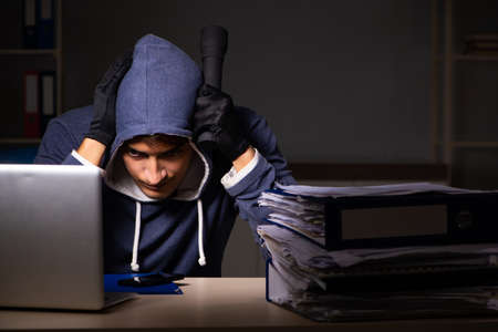 Thief trying to steal personal data in identity theft conceptの写真素材
