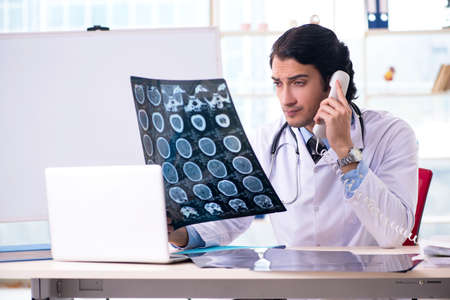Young handsome male radiologist in front of whiteboardの写真素材