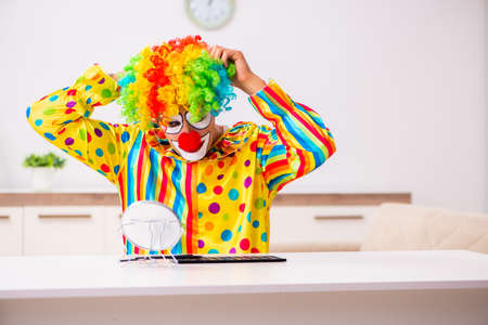 Male clown preparing for perfomance at home