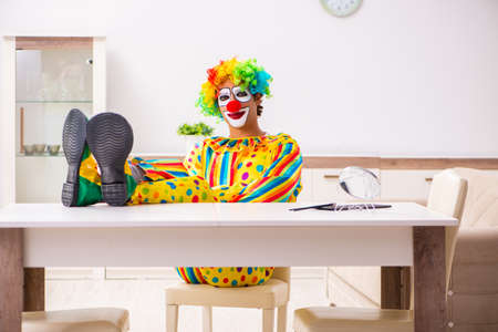 Male clown preparing for perfomance at home