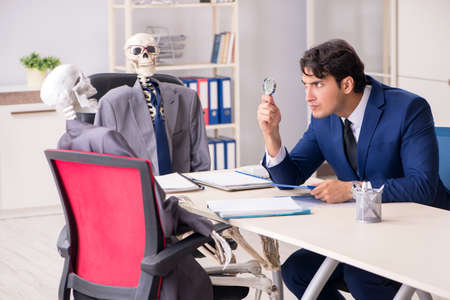Funny business meeting with boss and skeletonsの写真素材