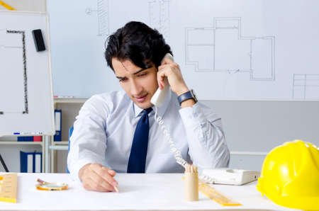 Young handsome architect working on the project