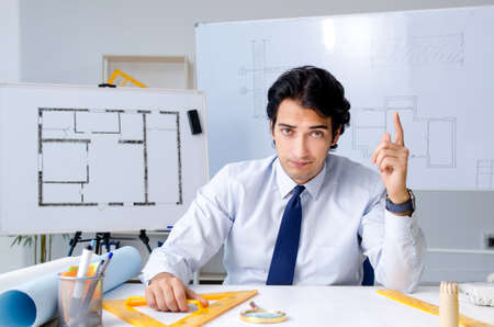Young handsome architect working on the project
