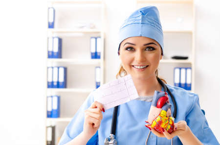 Young female doctor cardiologist sitting at the hospitalの写真素材