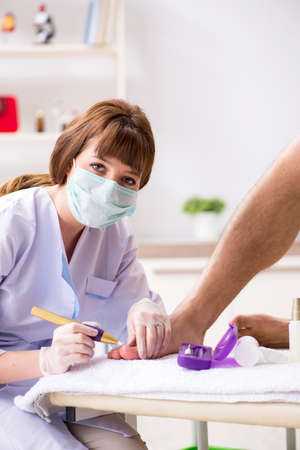 Podiatrist treating feet during procedureの写真素材