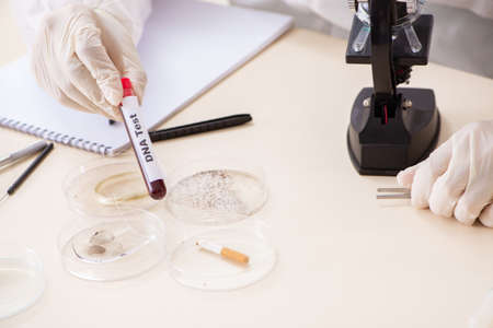 Young expert criminologist working in the lab