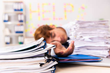 Young employee suffering from excessive workの写真素材