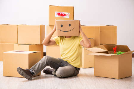 Happy man with box instead of his head
