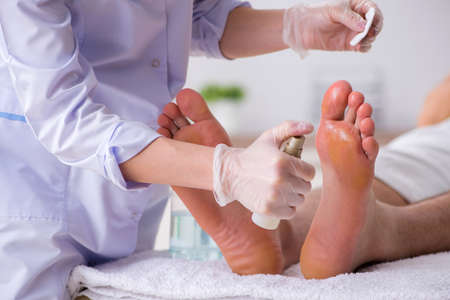 Podiatrist treating feet during procedureの写真素材