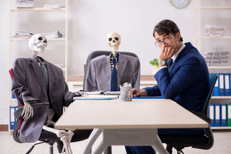 Funny business meeting with boss and skeletonsの写真素材