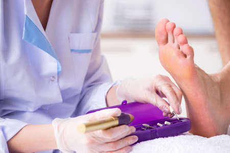 Podiatrist treating feet during procedureの写真素材