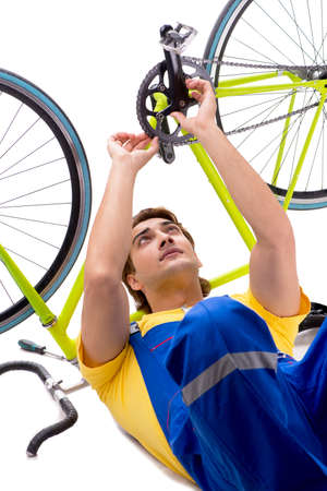 Man repairing his bike isolated on white backgroundの写真素材
