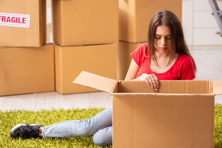 Young beautiful woman moving to new flat